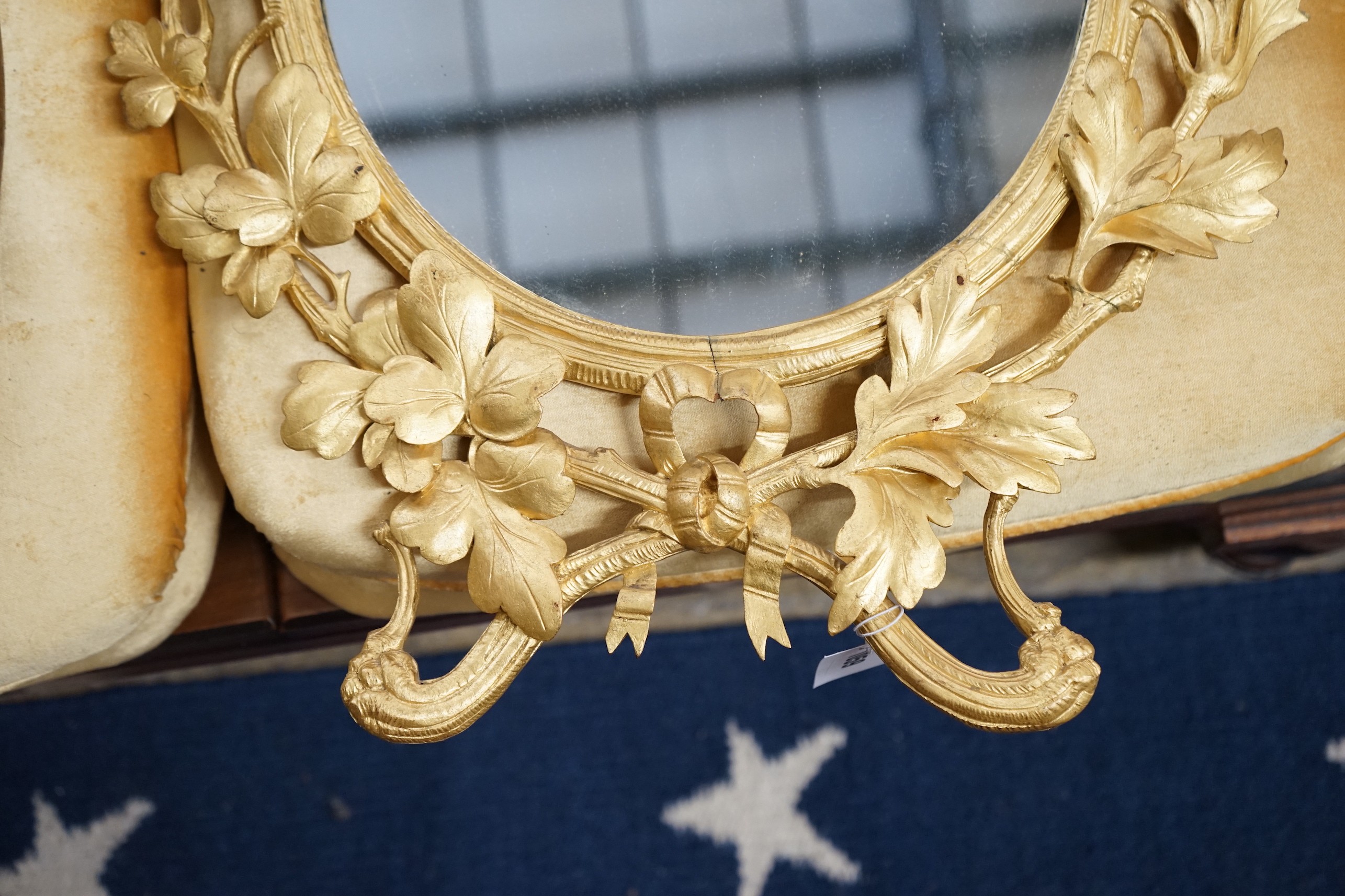 A Victorian oval carved giltwood wall mirror, width 49cm, height 66cm